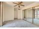 Bedroom with carpeting, a ceiling fan, mirrored closet, and doors to a private balcony at 1034 Tam O Shanter, Las Vegas, NV 89109
