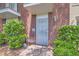 Charming brick townhome exterior features well maintained landscaping and secure front door at 1034 Tam O Shanter, Las Vegas, NV 89109