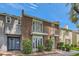Brick townhome exterior features symmetrical balconies and landscaped front yard, on a bright day at 1034 Tam O Shanter, Las Vegas, NV 89109