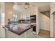The kitchen features white cabinets, bar seating, granite countertops, and stainless steel appliances at 1034 Tam O Shanter, Las Vegas, NV 89109