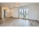Spacious living room with light wood-look tile floors and bright glass doors to the outside at 1034 Tam O Shanter, Las Vegas, NV 89109