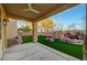 Inviting covered patio with a built-in water feature and lush artificial turf at 10530 Eagle Nest St, Las Vegas, NV 89141
