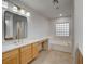 A bright bathroom features a soaking tub, dual vanities with stone countertops, and modern fixtures at 10530 Eagle Nest St, Las Vegas, NV 89141