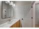 Contemporary half-bathroom with modern vanity, countertop, faucet and framed mirror at 10530 Eagle Nest St, Las Vegas, NV 89141