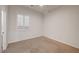This bedroom has neutral carpet, a window with blinds, and a closet at 10530 Eagle Nest St, Las Vegas, NV 89141