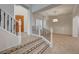 Bright entryway with staircase, decorative iron railing, tiled floors, and wood door at 10530 Eagle Nest St, Las Vegas, NV 89141