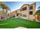 Exterior view showcasing a lush backyard with a waterfall and generous turf at 10530 Eagle Nest St, Las Vegas, NV 89141