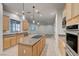 Open kitchen area with a central island and modern appliances at 10530 Eagle Nest St, Las Vegas, NV 89141