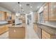 Bright kitchen with an island, tile flooring, and ample cabinet space at 10530 Eagle Nest St, Las Vegas, NV 89141