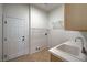 Functional laundry room with a utility sink and wire shelving at 10530 Eagle Nest St, Las Vegas, NV 89141