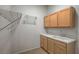 Laundry room featuring a utility sink, overhead lighting and shelving at 10530 Eagle Nest St, Las Vegas, NV 89141