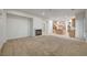 Large living room with carpet, fireplace and kitchen view at 10530 Eagle Nest St, Las Vegas, NV 89141