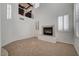Spacious living room showcasing a fireplace and a two-story ceiling with large windows and white shutters at 10530 Eagle Nest St, Las Vegas, NV 89141