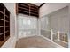 Carpeted loft area with bookshelves, wrought iron railing, and natural light at 10530 Eagle Nest St, Las Vegas, NV 89141