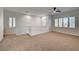 Bright loft space with carpet flooring, ceiling fan, and multiple windows for natural light at 10530 Eagle Nest St, Las Vegas, NV 89141