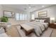 A beautifully staged main bedroom features a king-size bed, stylish seating, and modern decor at 10530 Eagle Nest St, Las Vegas, NV 89141