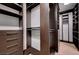 Custom walk-in closet features dark wood shelving and drawers, maximizing storage space at 10530 Eagle Nest St, Las Vegas, NV 89141