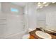 Bright bathroom with a shower-over-tub combo, granite counter tops, and a tiled surround at 11356 Belmont Lake Dr # 103, Las Vegas, NV 89135