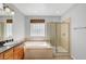 Bathroom showcasing double sinks, soaking tub, glass block window, and a glass shower at 11356 Belmont Lake Dr # 103, Las Vegas, NV 89135