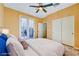 This staged bedroom shows wood flooring, slider to backyard, and double door closet at 11356 Belmont Lake Dr # 103, Las Vegas, NV 89135
