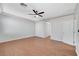 Spacious bedroom featuring wood-look floors, neutral paint, and a ceiling fan at 11356 Belmont Lake Dr # 103, Las Vegas, NV 89135