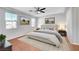 Staged bedroom features neutral paint, modern furniture, and wood-look flooring at 11356 Belmont Lake Dr # 103, Las Vegas, NV 89135