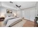 Staged bedroom features neutral paint, modern furniture, and wood-look flooring at 11356 Belmont Lake Dr # 103, Las Vegas, NV 89135