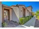 Exterior view of a well-maintained property with trimmed hedges and a paved walkway at 11356 Belmont Lake Dr # 103, Las Vegas, NV 89135