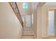 Bright foyer showcasing tile floors, staircase with wood handrail, and access to multiple rooms at 11356 Belmont Lake Dr # 103, Las Vegas, NV 89135