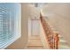 Welcoming foyer with tile flooring, staircase, and natural light from a nearby window at 11356 Belmont Lake Dr # 103, Las Vegas, NV 89135