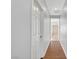 Hallway view with wood floor leading to a bathroom with a white door on the left at 11356 Belmont Lake Dr # 103, Las Vegas, NV 89135