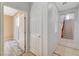 Hallway featuring tile flooring with doors leading to a bedroom and stairs at 11356 Belmont Lake Dr # 103, Las Vegas, NV 89135