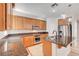 Functional kitchen with granite counters, modern appliances, and wooden cabinets providing ample storage and counter space at 11356 Belmont Lake Dr # 103, Las Vegas, NV 89135