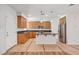 Well-lit kitchen featuring granite countertops, stainless steel appliances, a central island, and ample wooden cabinetry at 11356 Belmont Lake Dr # 103, Las Vegas, NV 89135