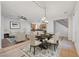 Staged open living space with dining area, featuring a large kitchen and comfortable seating area with stylish decor at 11356 Belmont Lake Dr # 103, Las Vegas, NV 89135