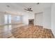 Spacious living area with a stone fireplace, tile flooring, and a modern ceiling fan; features sliding glass doors to the outside at 11356 Belmont Lake Dr # 103, Las Vegas, NV 89135