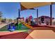 Colorful community playground with climbing structures and slides at 11356 Belmont Lake Dr # 103, Las Vegas, NV 89135