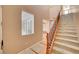 View of the staircase featuring carpeted steps and decorative wood banister in a neutral color palette at 11356 Belmont Lake Dr # 103, Las Vegas, NV 89135