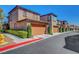 Row of townhomes showing private garages with well maintained landscaping at 11356 Belmont Lake Dr # 103, Las Vegas, NV 89135