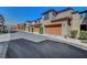 Row of townhomes showing private garages with well maintained landscaping at 11356 Belmont Lake Dr # 103, Las Vegas, NV 89135