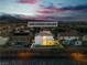 An aerial view of 1136 Casady Hollow, a two-story home featuring a backyard and mountain views at sunset at 1136 Casady Hollow Ave, Henderson, NV 89012