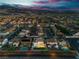 Aerial view of a two-story home featuring a well-manicured backyard with a view of the mountains at dusk at 1136 Casady Hollow Ave, Henderson, NV 89012