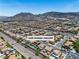 A wide aerial view capturing the neighborhood and surrounding mountains at 1136 Casady Hollow Ave, Henderson, NV 89012