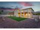 Spacious backyard featuring a covered patio and a well-maintained artificial grass area at 1136 Casady Hollow Ave, Henderson, NV 89012