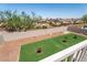 Well-maintained backyard with lush artificial turf, desert landscaping, and privacy wall at 1136 Casady Hollow Ave, Henderson, NV 89012