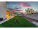 Spacious backyard featuring artificial grass and a covered patio, perfect for entertaining or relaxing at 1136 Casady Hollow Ave, Henderson, NV 89012
