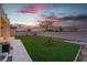 Inviting backyard featuring artificial grass, desert landscaping, and a privacy fence at 1136 Casady Hollow Ave, Henderson, NV 89012