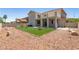 Expansive backyard with manicured lawn and decorative rock landscaping and covered patio at 1136 Casady Hollow Ave, Henderson, NV 89012
