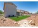The backyard features a low-maintenance xeriscape with an artificial lawn and a covered patio at 1136 Casady Hollow Ave, Henderson, NV 89012