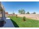 A spacious backyard features low-maintenance turf, tasteful desert landscaping, and a custom patio at 1136 Casady Hollow Ave, Henderson, NV 89012